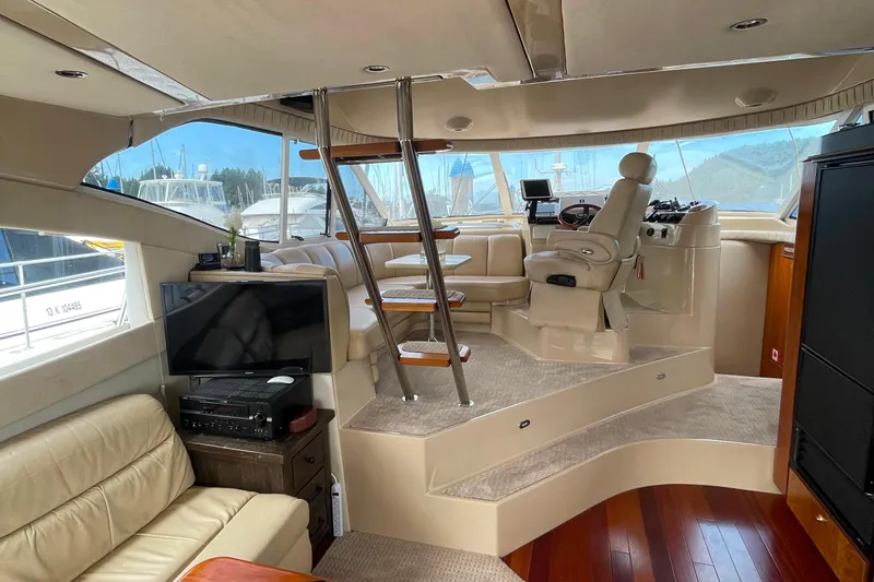  Yacht Photos Pics Interior of 2001 Cruisers Yachts 5000 Pilothouse with helm, seating, and entertainment area.