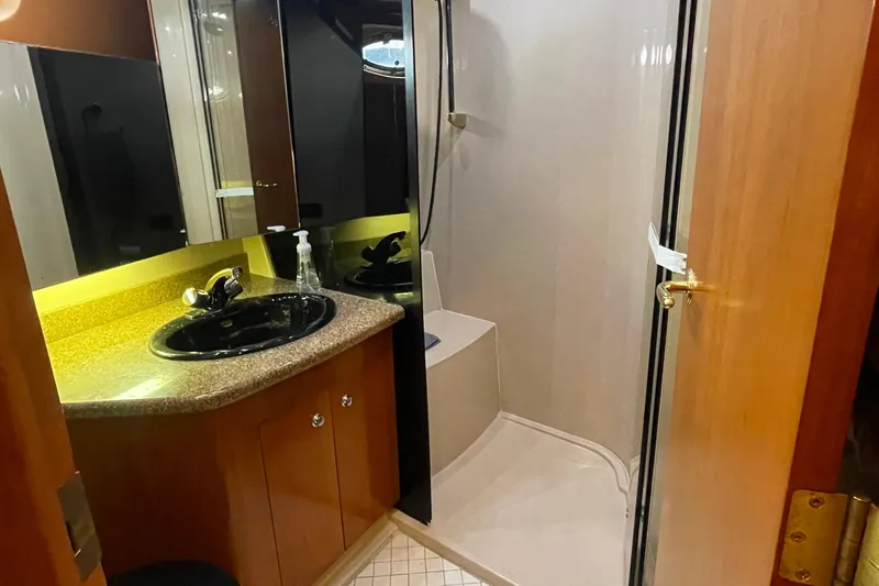  Yacht Photos Pics Bathroom interior of 2001 Cruisers Yachts 5000 Pilothouse with sink and shower.