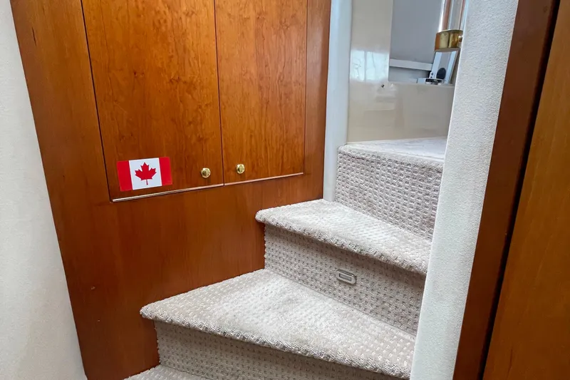  Yacht Photos Pics Staircase in 2001 Cruisers Yachts 5000 Pilothouse with Canadian flag sticker.
