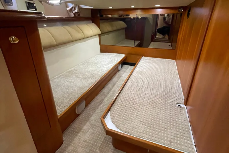  Yacht Photos Pics 2001 Cruisers Yachts 5000 Pilothouse interior with twin beds and wooden paneling.