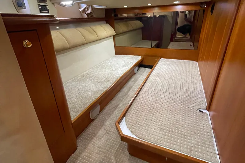  Yacht Photos Pics 2001 Cruisers Yachts 5000 Pilothouse interior with twin beds and wood paneling.