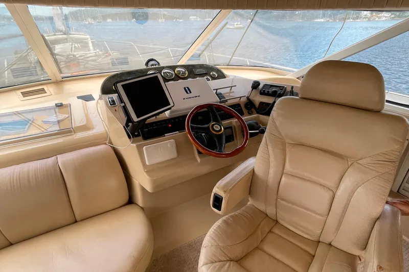  Yacht Photos Pics Pilothouse interior of 2001 Cruisers Yachts 5000, featuring helm and seating.