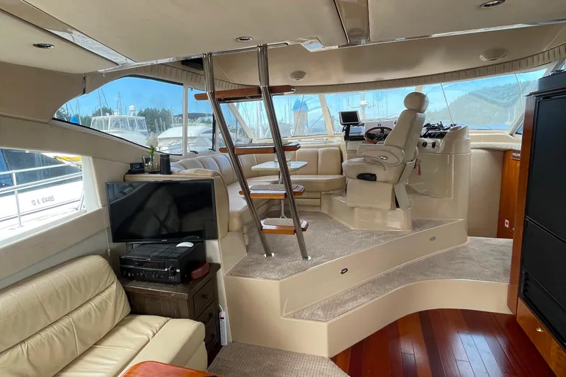  Yacht Photos Pics Luxurious interior of 2001 Cruisers Yachts 5000 Pilothouse with helm and seating area.