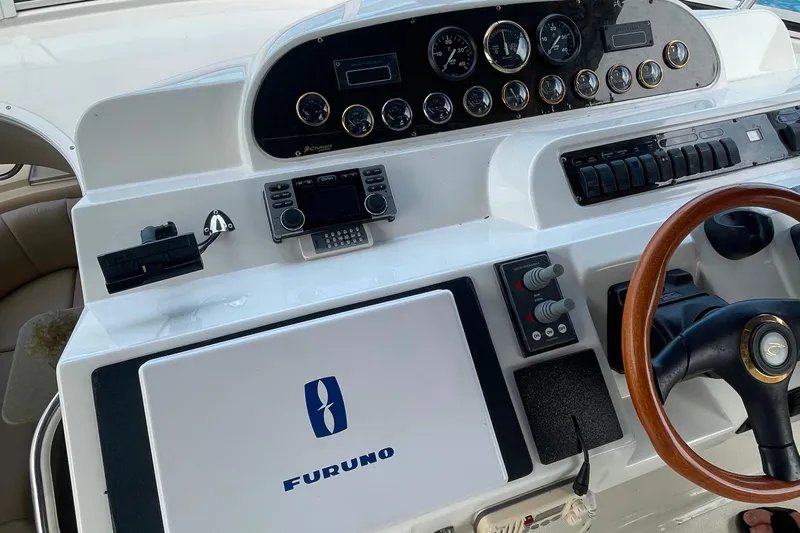  Yacht Photos Pics 2001 Cruisers Yachts 5000 Pilothouse helm with Furuno navigation and wooden steering wheel.