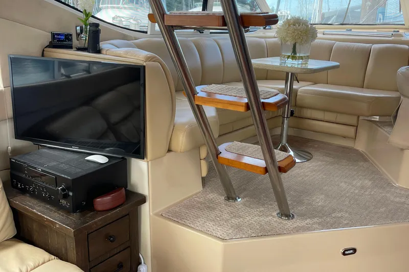  Yacht Photos Pics Luxurious interior of 2001 Cruisers Yachts 5000 Pilothouse with TV and seating area.