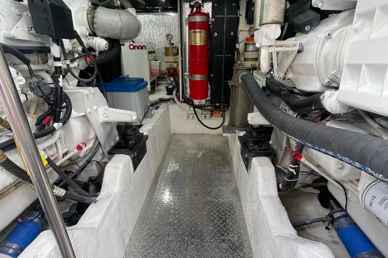  Yacht Photos Pics Engine room of 2001 Cruisers Yachts 5000 Pilothouse with mechanical components and fire extinguisher.