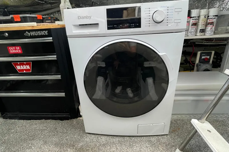  Yacht Photos Pics Danby washing machine in a garage, next to a Husky tool chest and spray cans.