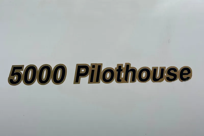  Yacht Photos Pics 2001 Cruisers Yachts 5000 Pilothouse logo on white background.