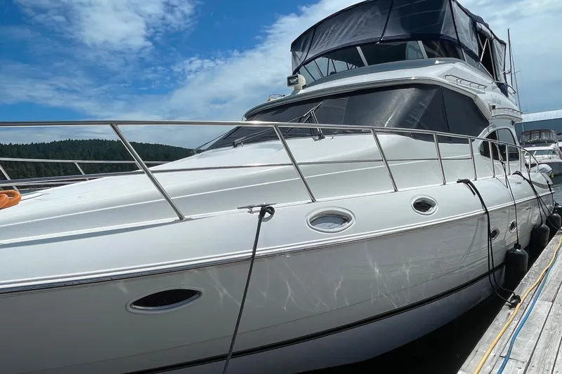  Yacht Photos Pics 2001 Cruisers Yachts 5000 Pilothouse docked under a clear blue sky.
