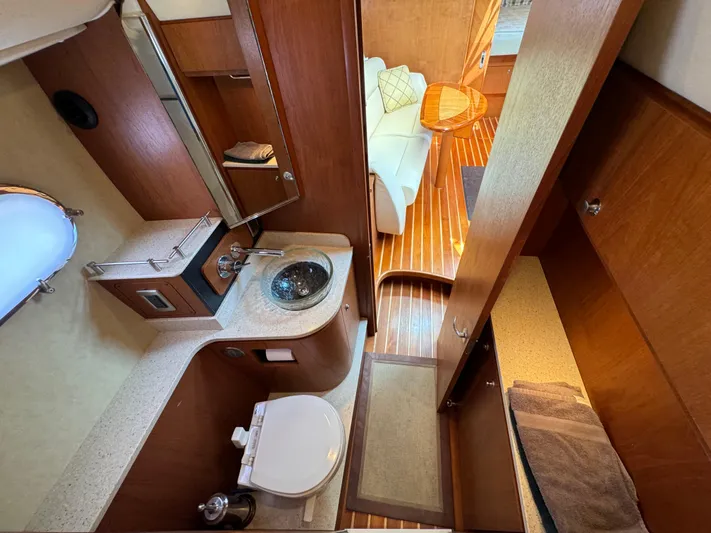 Ost - 39044 Yacht Photos Pics Luxurious 2008 Tiara Yachts 3900 Sovran bathroom with modern amenities and elegant wood finishes.