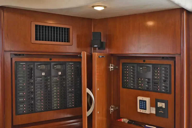 Chirstina Maria Yacht Photos Pics Electrical panel inside 2009 Silverton 52 Ovation yacht, featuring wooden cabinetry and control systems.