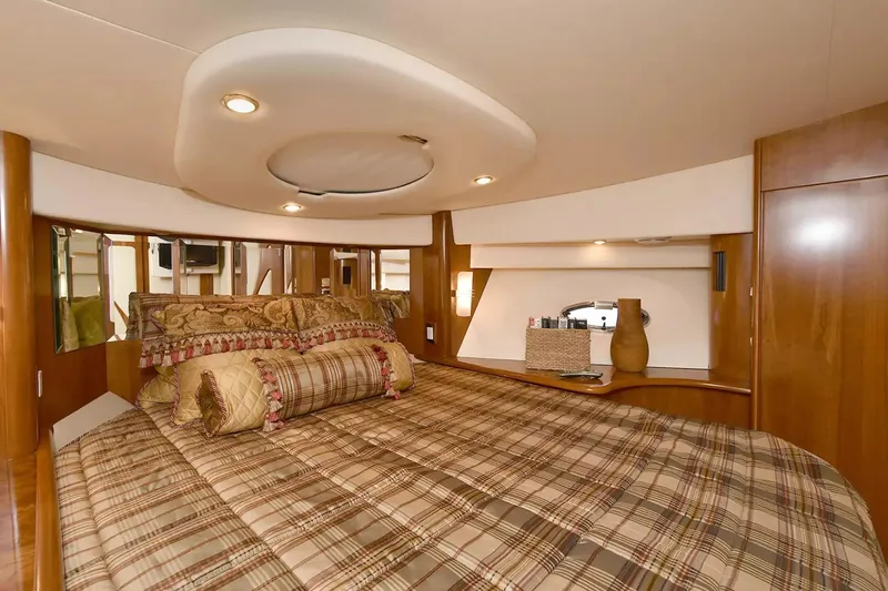 Chirstina Maria Yacht Photos Pics Luxurious bedroom interior of 2009 Silverton 52 Ovation yacht with plaid bedding and elegant decor.