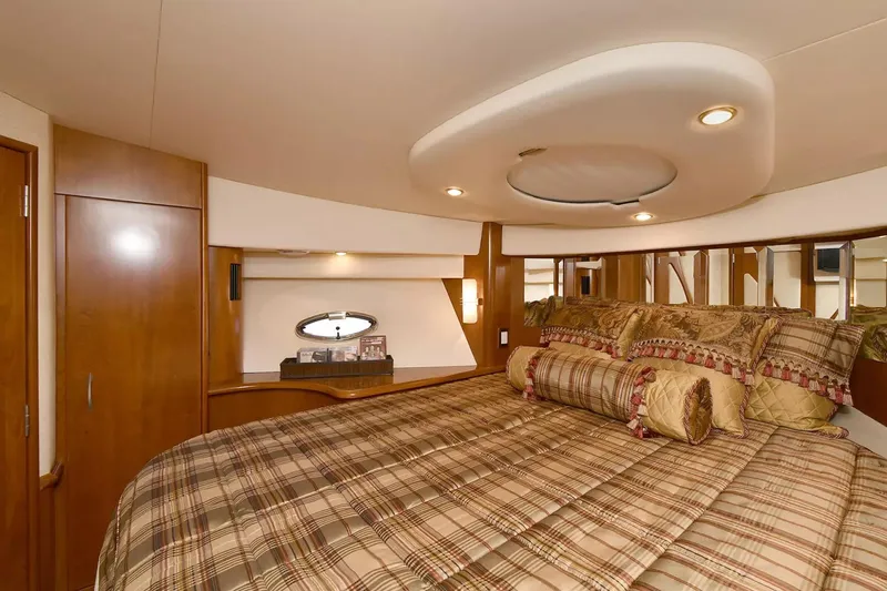 Chirstina Maria Yacht Photos Pics Luxurious bedroom interior of 2009 Silverton 52 Ovation yacht with elegant bedding and wood finishes.