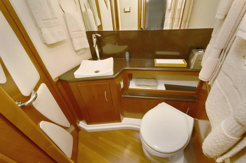 Chirstina Maria Yacht Photos Pics Luxurious bathroom in 2009 Silverton 52 Ovation yacht with modern fixtures and wooden cabinetry.