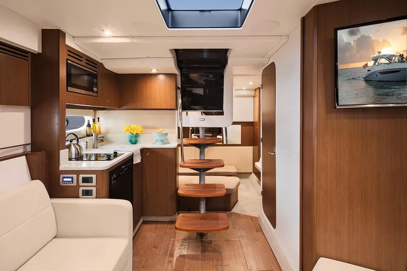  Yacht Photos Pics 2018 Sea Ray Sundancer 350 Coupe interior with modern kitchen and wooden staircase.