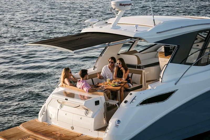  Yacht Photos Pics 2018 Sea Ray Sundancer 350 Coupe with people dining on deck.
