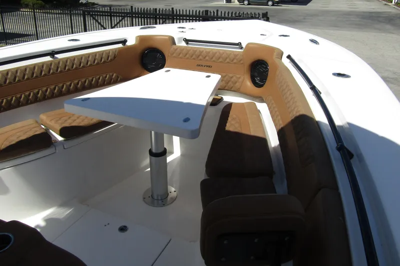  Yacht Photos Pics 2025 Sea Pro 322 Offshore boat interior with cushioned seating and table.