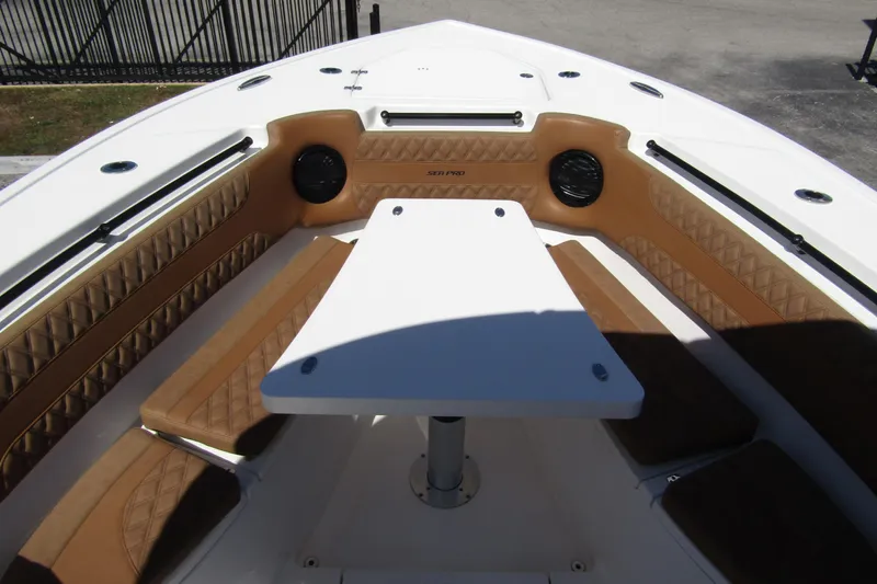  Yacht Photos Pics 2025 Sea Pro 322 Offshore boat interior with cushioned seating and table.