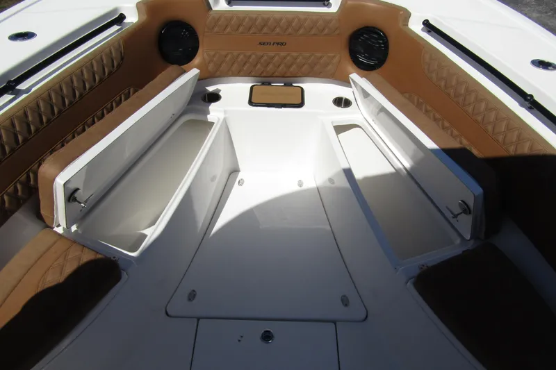  Yacht Photos Pics 2025 Sea Pro 322 Offshore boat interior with open storage compartments and cushioned seating.