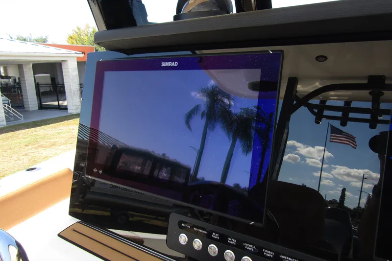  Yacht Photos Pics Simrad display on 2025 Sea Pro 322 Offshore boat, reflecting palm trees and American flag.
