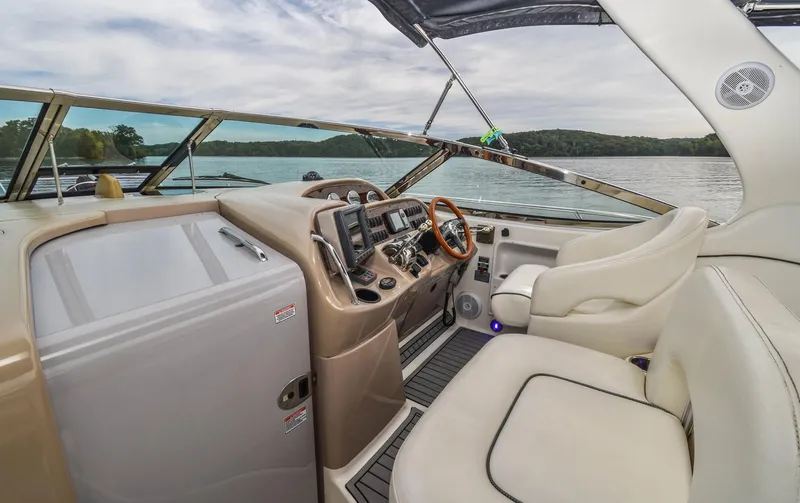  Yacht Photos Pics 2005 Sea Ray 360 Sundancer helm with modern controls and scenic lake view.