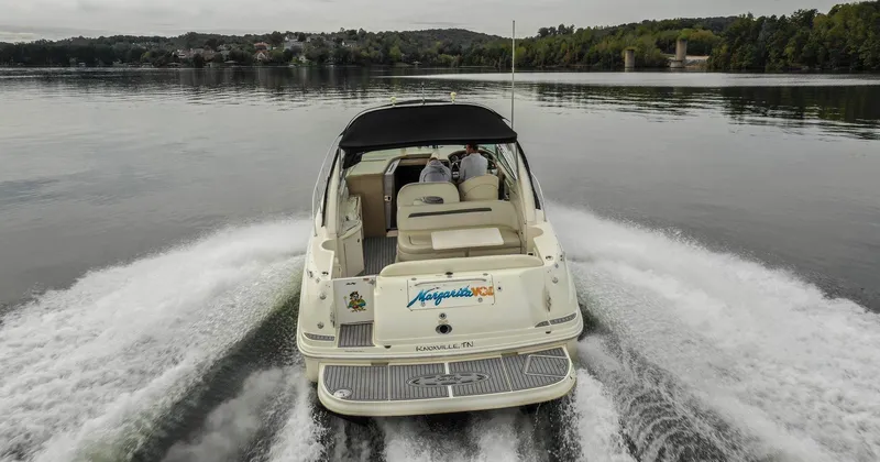  Yacht Photos Pics 2005 Sea Ray 360 Sundancer cruising on a calm lake, rear view.