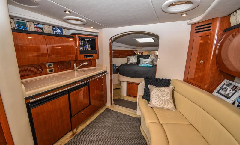  Yacht Photos Pics Interior of 2005 Sea Ray 360 Sundancer yacht with kitchen and cozy seating area.