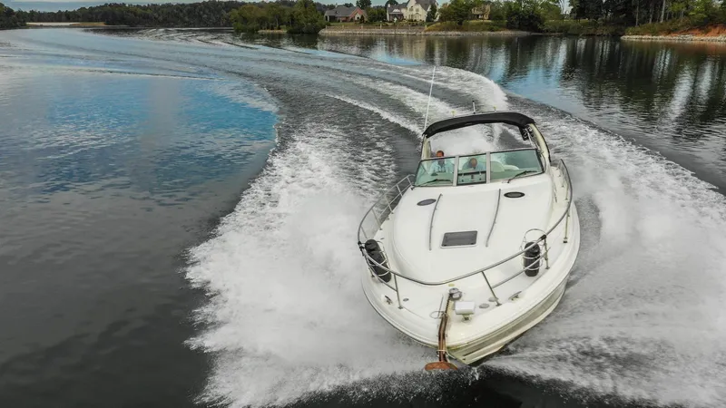  Yacht Photos Pics 2005 Sea Ray 360 Sundancer cruising on a serene lake.