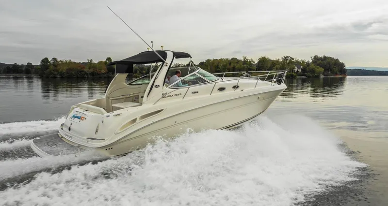  Yacht Photos Pics 2005 Sea Ray 360 Sundancer cruising on a calm lake, creating a wake.