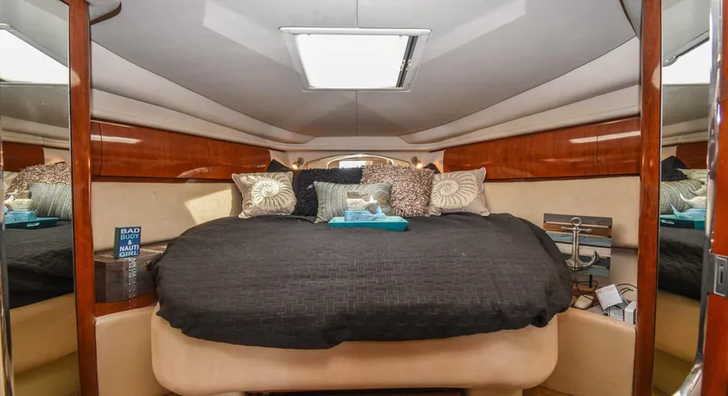  Yacht Photos Pics Luxurious cabin interior of 2005 Sea Ray 360 Sundancer with plush bedding and elegant wood finishes.