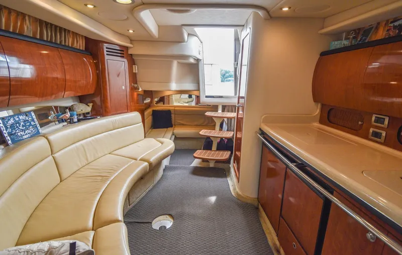  Yacht Photos Pics Interior of 2005 Sea Ray 360 Sundancer yacht with luxurious seating and wooden cabinetry.