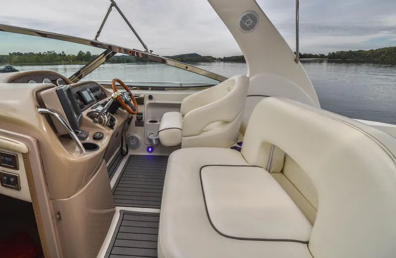  Yacht Photos Pics 2005 Sea Ray 360 Sundancer interior with plush seating and modern dashboard on calm water.