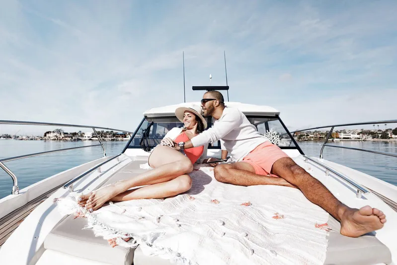  Yacht Photos Pics Manufacturer Provided Image: Couple relaxing on 2023 Prestige 420 S yacht deck, enjoying a sunny day.