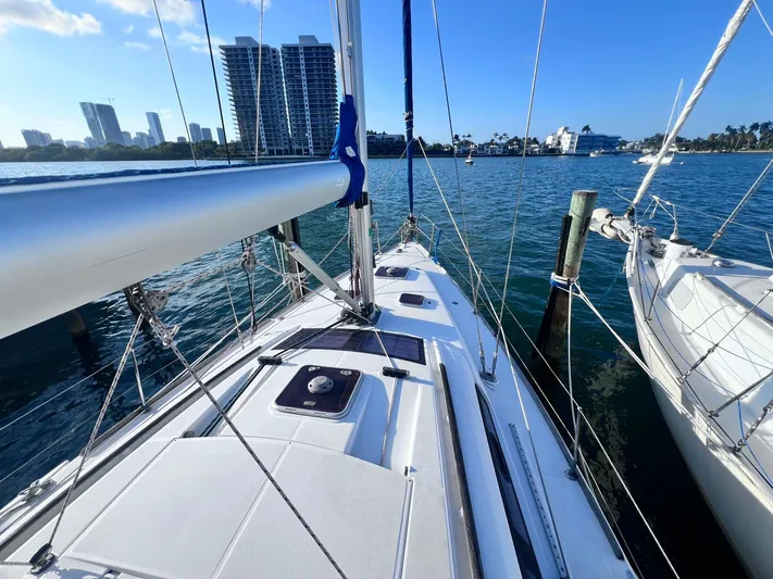  Yacht Photos Pics 2009 Beneteau America Oceanis 41 sailboat docked in a marina with city skyline.