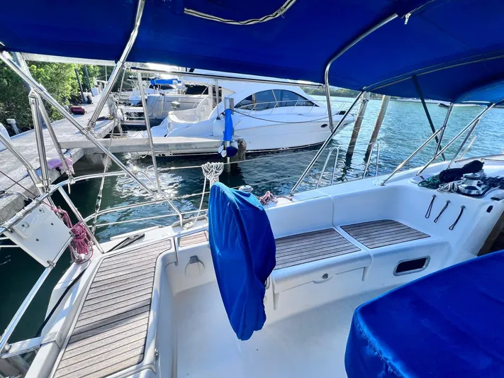  Yacht Photos Pics Beneteau America Oceanis 41 (2009) sailboat cockpit with blue canopy, docked at marina.