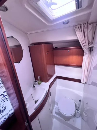  Yacht Photos Pics 2009 Beneteau America Oceanis 41 yacht bathroom with sink, toilet, and storage cabinets.