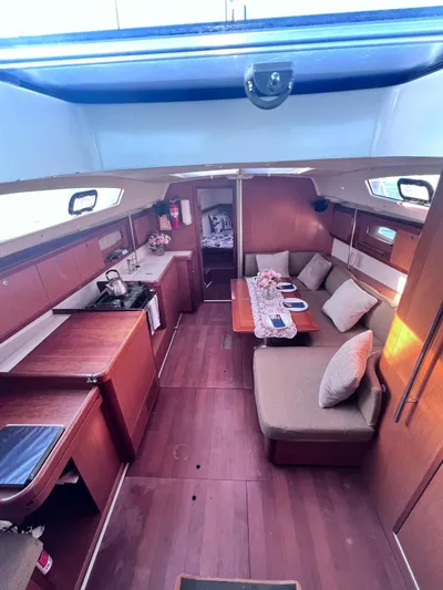  Yacht Photos Pics Interior of 2009 Beneteau America Oceanis 41 sailboat with cozy seating and wooden finishes.