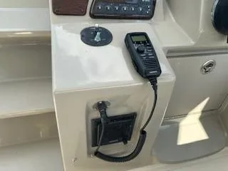 Hanky Panky Yacht Photos Pics Control panel of a 2012 Sea Ray 350 Sundancer boat with a radio handset.