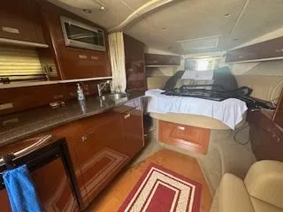 Hanky Panky Yacht Photos Pics Interior of 2012 Sea Ray 350 Sundancer yacht with kitchen and sleeping area.