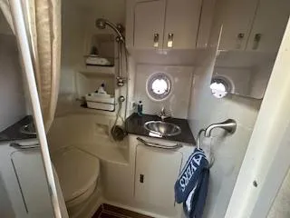 Hanky Panky Yacht Photos Pics 2012 Sea Ray 350 Sundancer bathroom with sink, toilet, and storage cabinets.