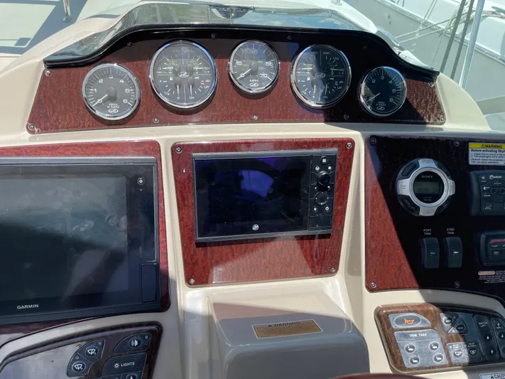 Hanky Panky Yacht Photos Pics Control panel of a 2012 Sea Ray 350 Sundancer boat with gauges and navigation screens.