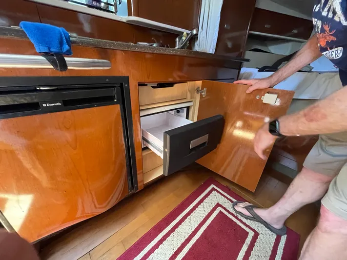 Hanky Panky Yacht Photos Pics Interior of 2012 Sea Ray 350 Sundancer with open cabinet and refrigerator.
