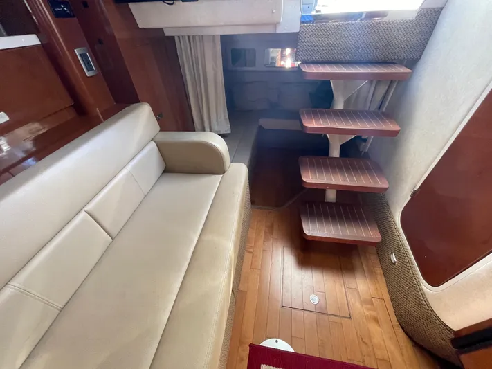 Hanky Panky Yacht Photos Pics Interior of 2012 Sea Ray 350 Sundancer with beige sofa and wooden steps.