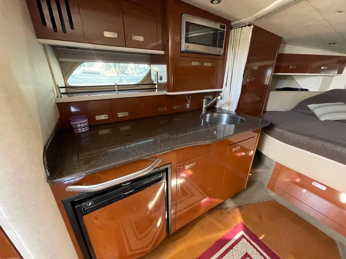 Hanky Panky Yacht Photos Pics Interior of 2012 Sea Ray 350 Sundancer yacht with kitchenette and sleeping area.
