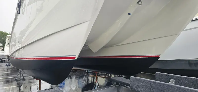  Yacht Photos Pics 2016 World Cat 320 boat hull with red stripe, displayed on a trailer.