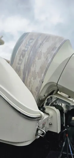  Yacht Photos Pics 2016 World Cat 320 boat with Suzuki outboard motor, viewed from the side.