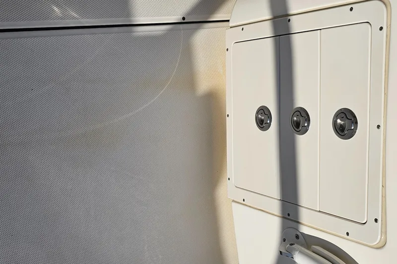  Yacht Photos Pics Interior view of a 2016 World Cat 320 boat, featuring a white panel with three circular fixtures.