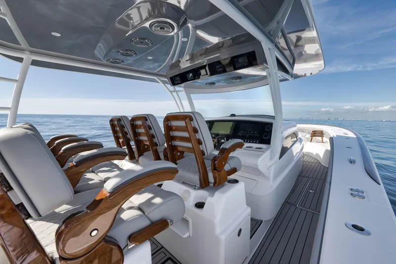  Yacht Photos Pics 2024 Valhalla Boatworks V-46 luxury boat interior with sleek seating and advanced controls.