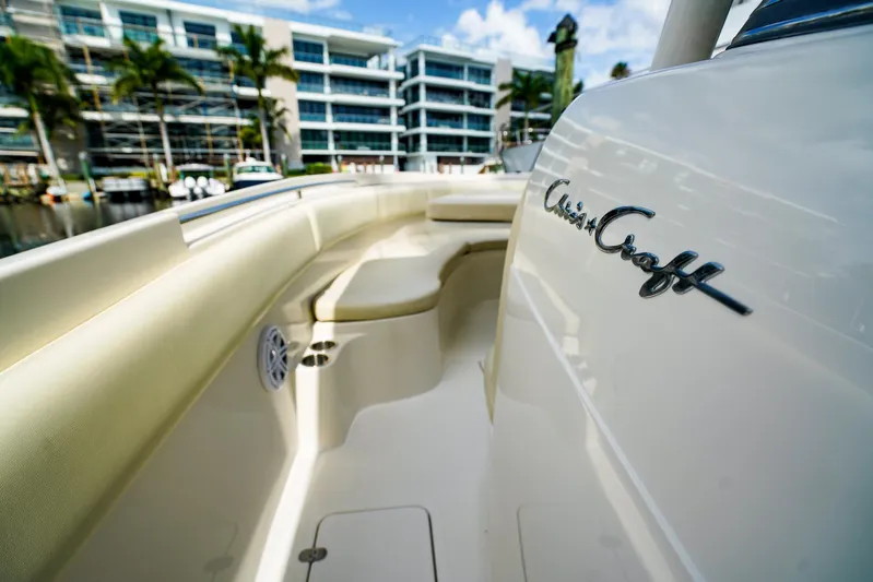 Tender Offer Yacht Photos Pics 2008 Chris-Craft Catalina 29 boat with sleek design, docked near modern buildings.