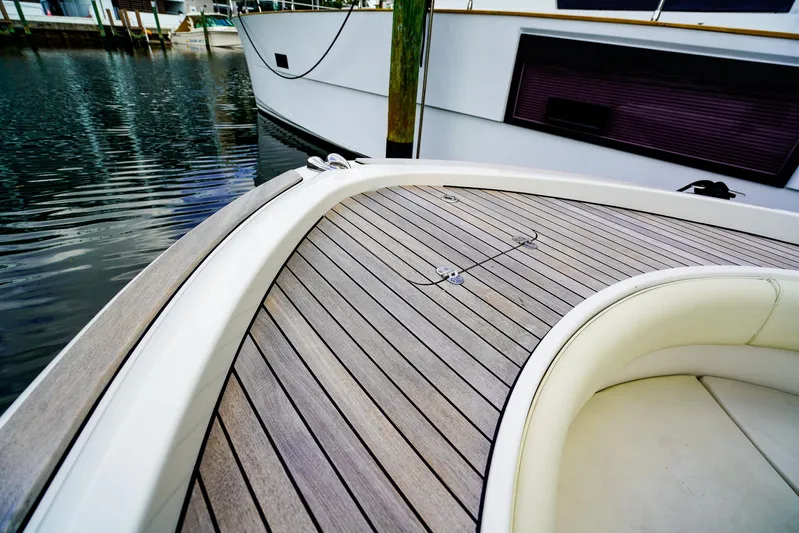 Tender Offer Yacht Photos Pics 2008 Chris-Craft Catalina 29 boat with sleek wooden deck, docked by the water.